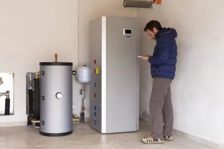 Plumber checking electric consumption of pump