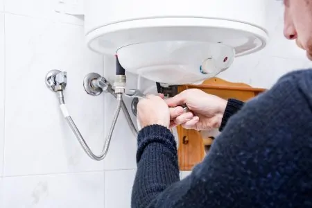 Person repairing a tankless water heater