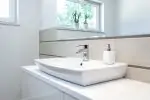 A white bathroom faucet