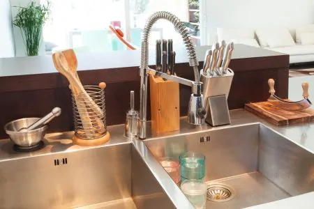 A pull down faucet in a commercial style kitchen