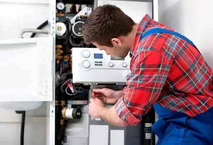 Technician troubleshooting a problem of a tankless water heater