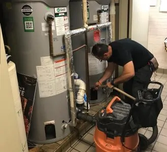 Man flushing a water heater