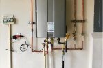 Tankless water heating system mounted on the wall