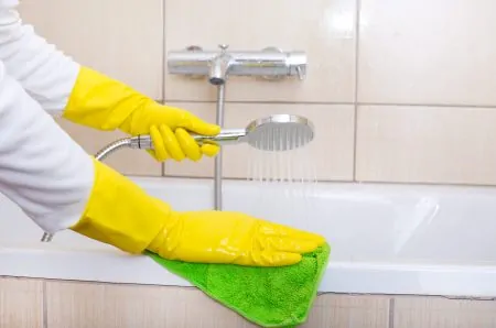 Woman cleaning bathtub