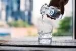 Pouring alkaline water for drinking