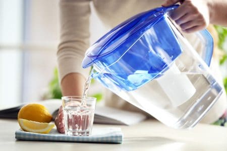 Woman pouring water from the best water filter pitcher