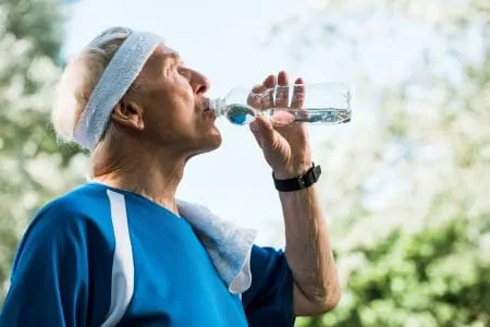 Elderly man drinking alkaline water