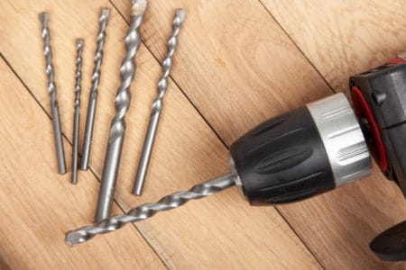 A hand drill and drill bits