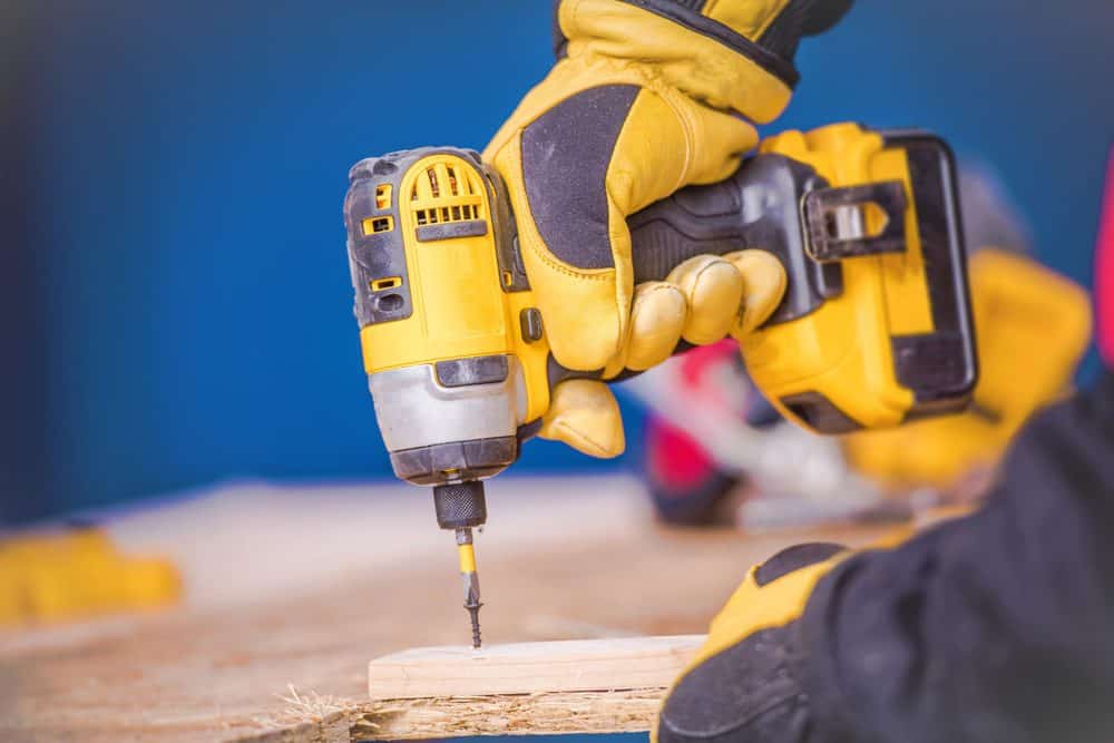 Man drilling into wood with an impact driver