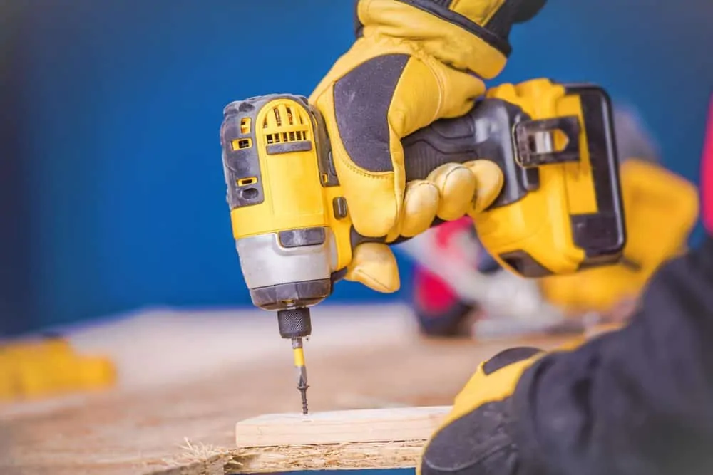 Man drilling into wood with an impact driver