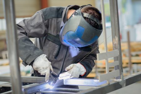 Man in welding coat with a gas torch