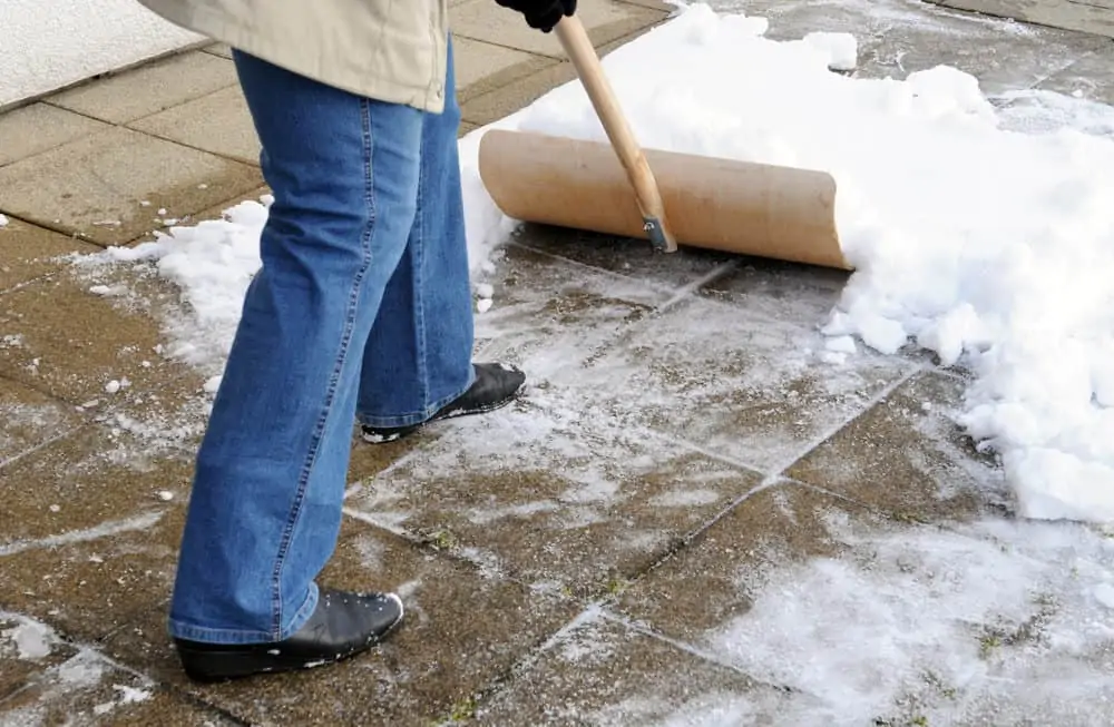 Shoveling snow from gravel