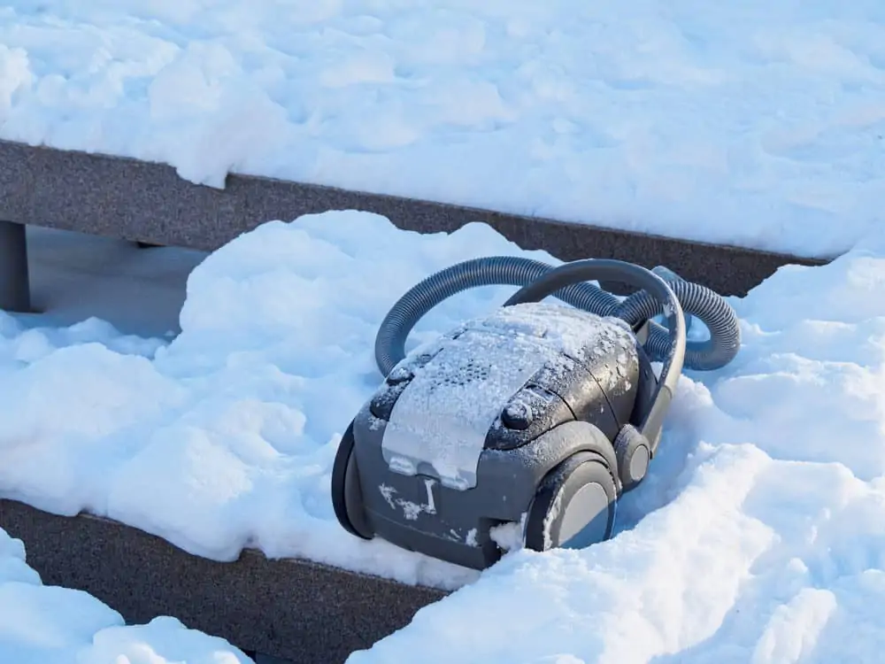 Discarded vacuum cleaner outdoors in the snow