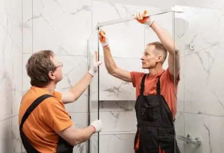 Workers connecting shower doors