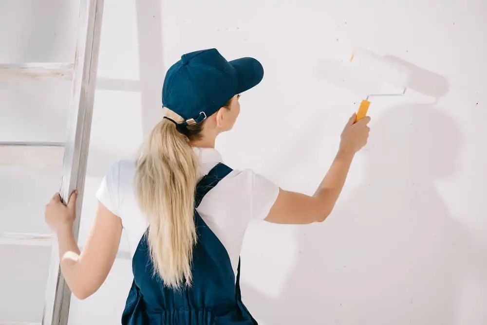 Woman painting a wall