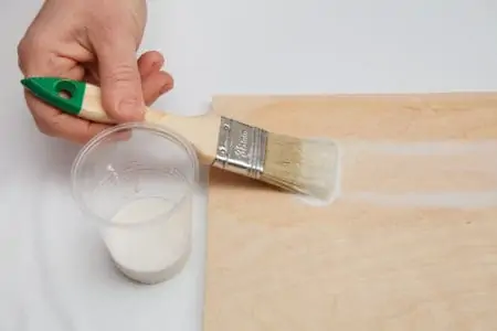 Hand painting plywood with paintbrush