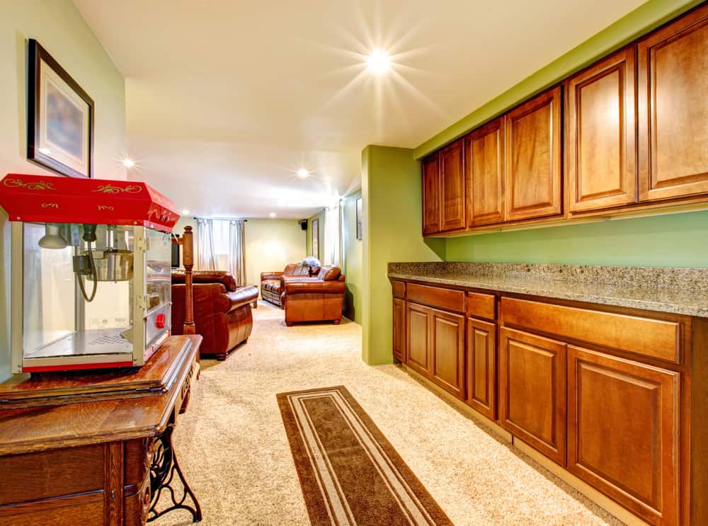 Basement interior with cabinets, green walls and popcorn machine.