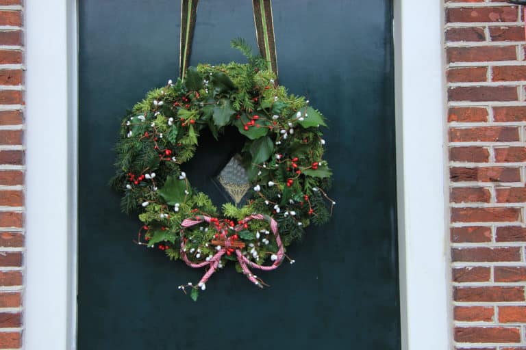 Classic christmas wreath with decorations on a door