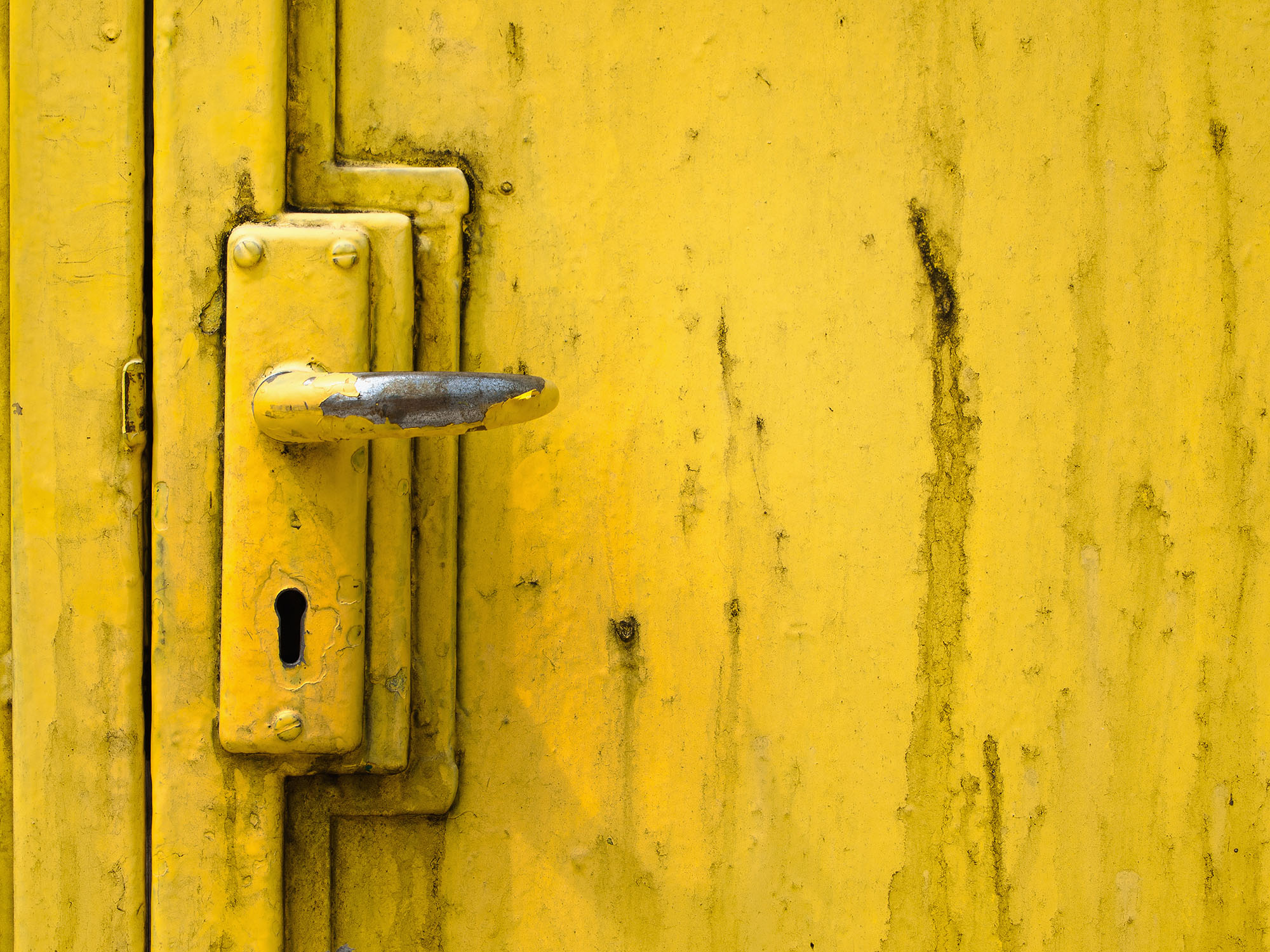 Door handle and steel door painted yellow