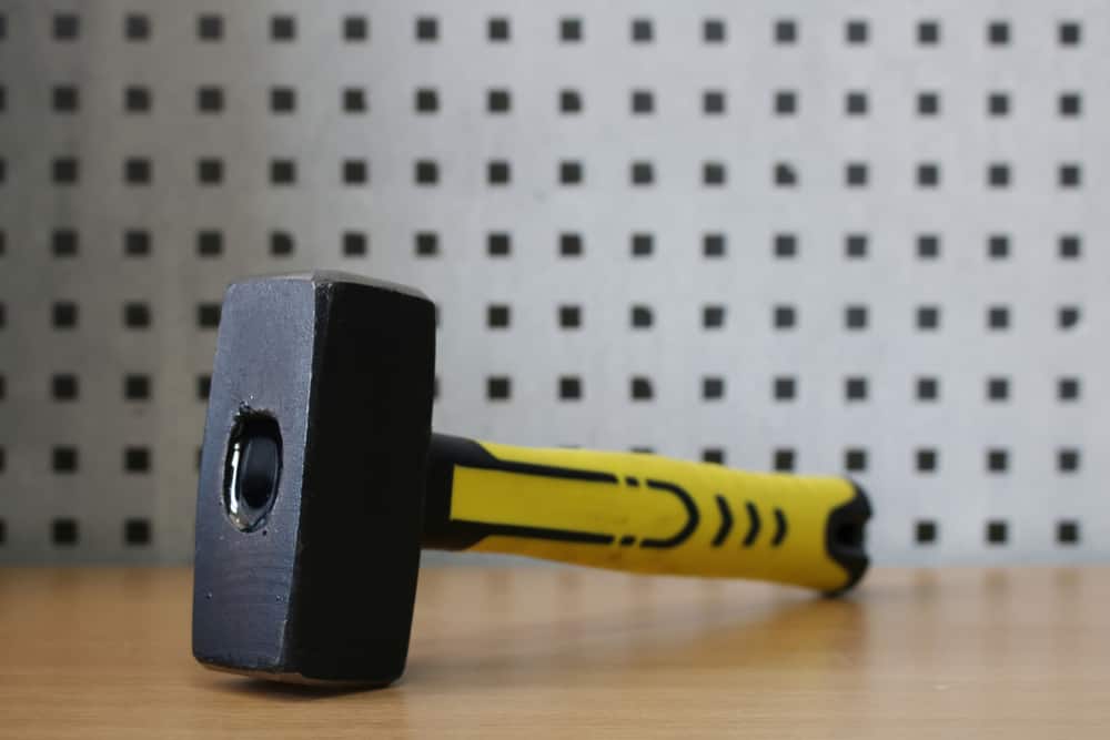 Sledge hammer with rubberized handle in yellow color