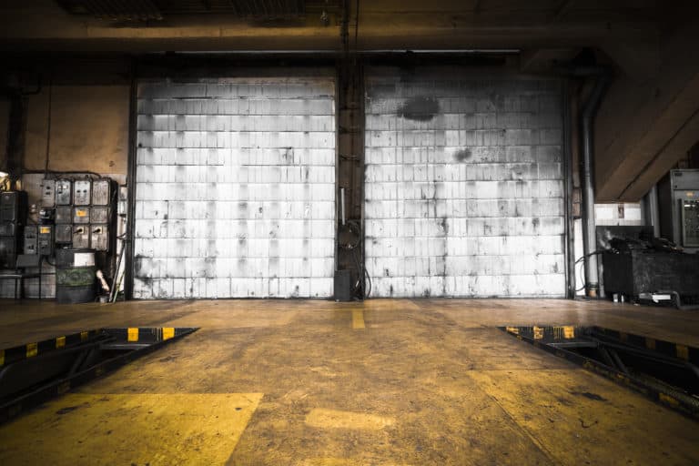dirty, oily door of the bus garage