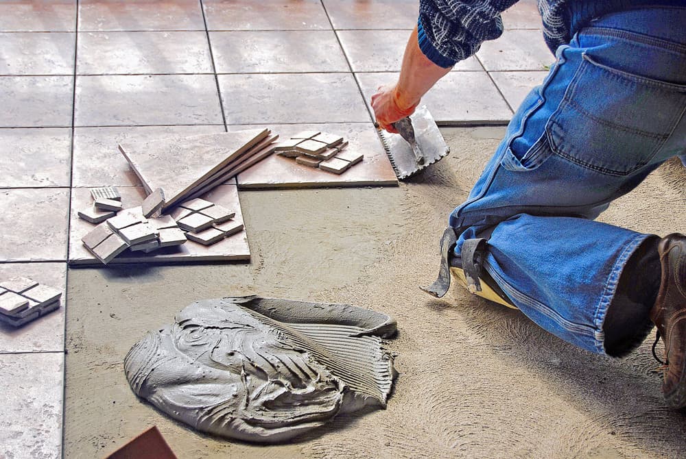 Worker removing ceramic tiles