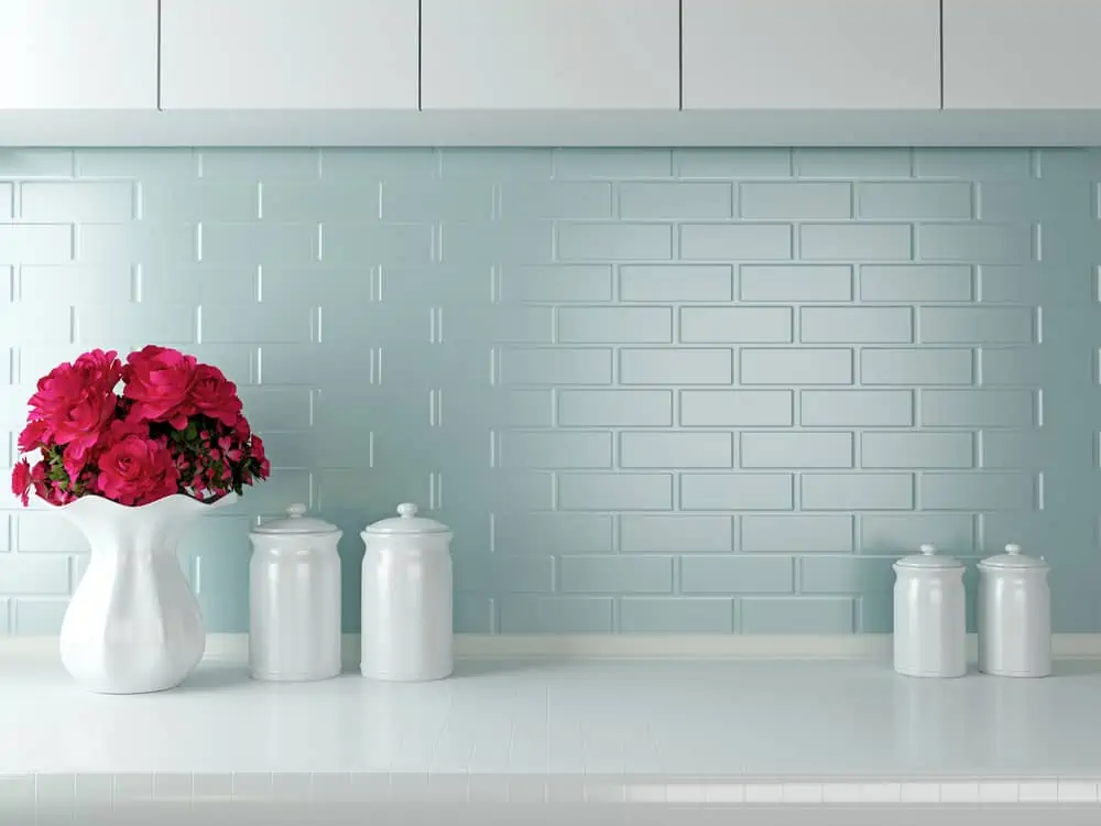 Ceramic tableware on the worktop. White kitchen design.