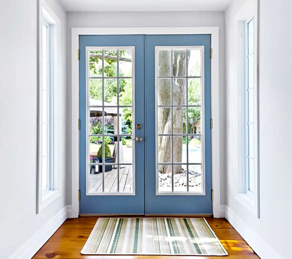 Double patio french doors with windows exiting to sunny backyard