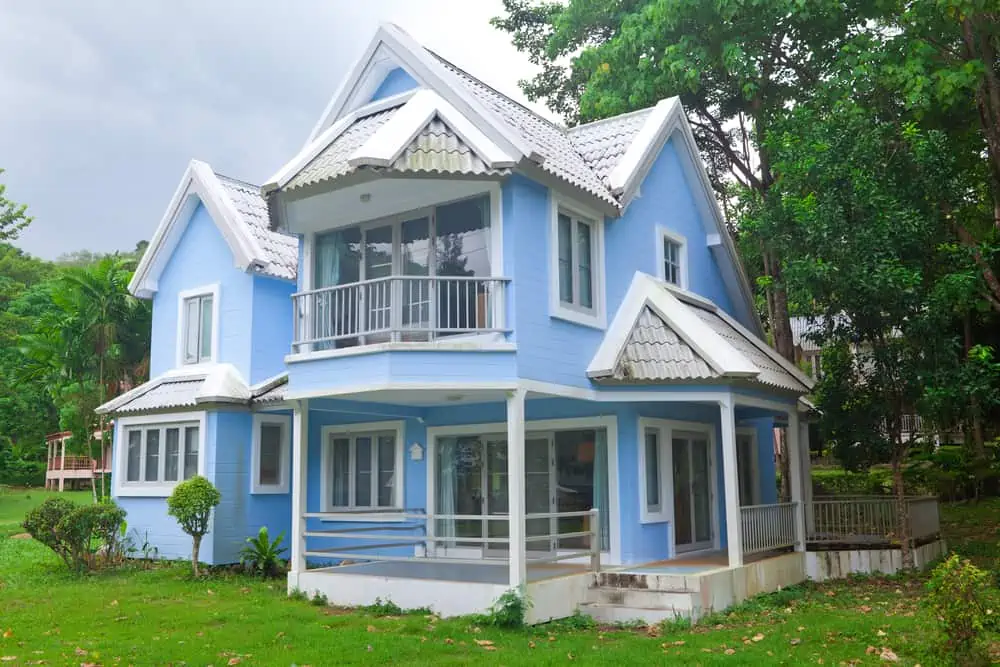 Beautiful blue house and big tree in forest