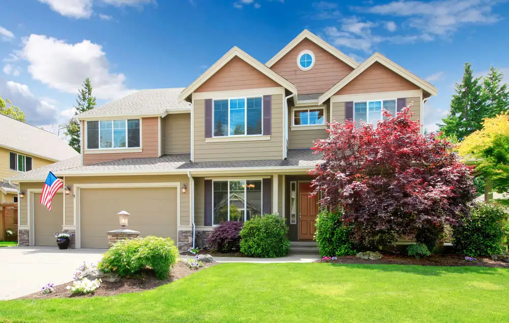 American beige luxury large house front exterior with landscape.