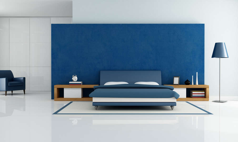 contemporary blue bedroom with white wardrobe and armchair - rendering