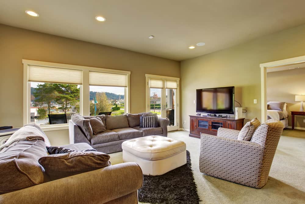 secondary Living room with carpet, windows, and water view.