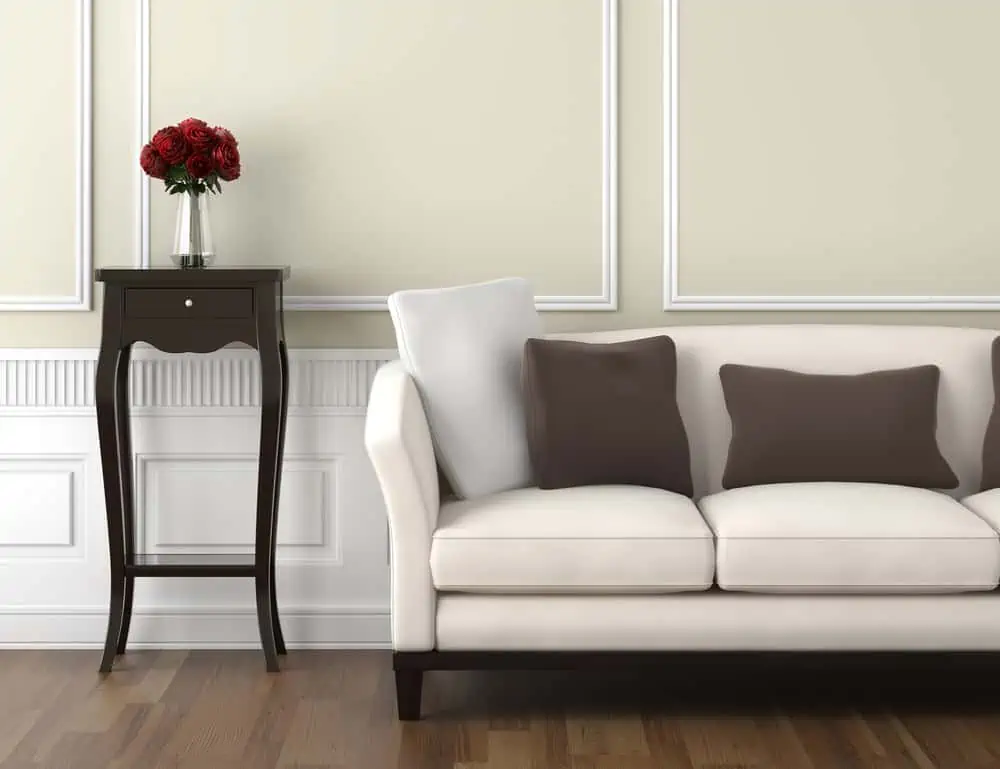 interior design of classic room in beige and white colors with couch table and a vase of roses, copy space on top half