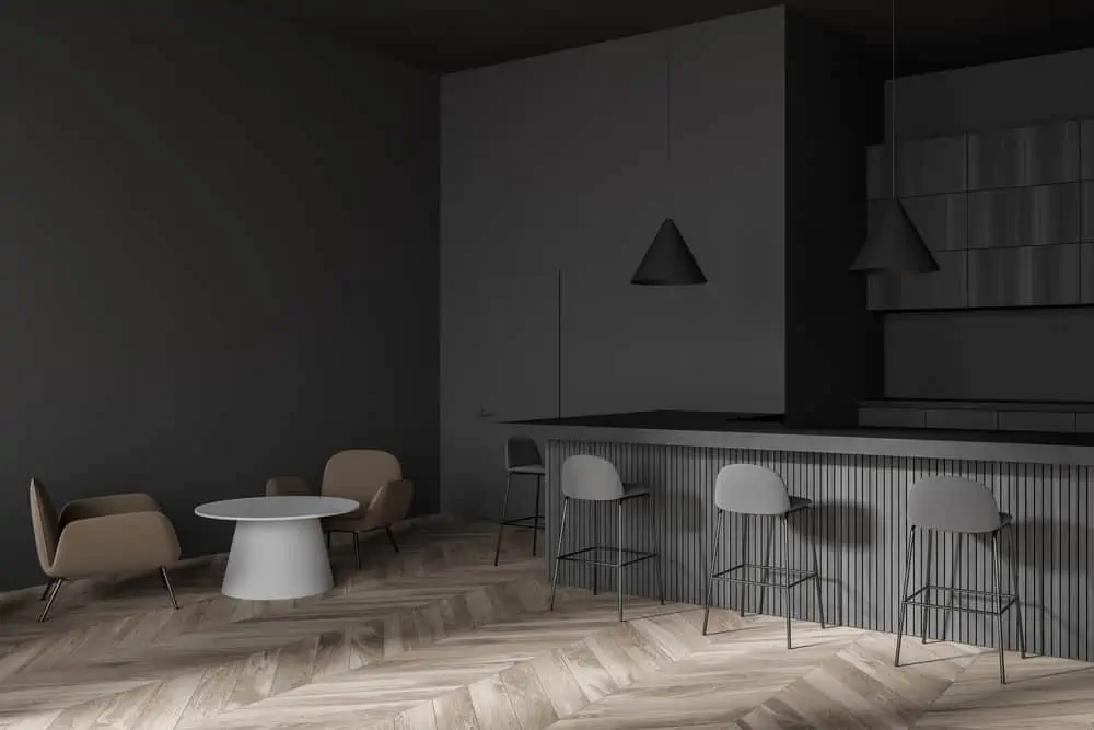 Corner of modern cafe bar with dark gray walls, wooden floor, round tables with brown chairs and bar counter. 3d rendering