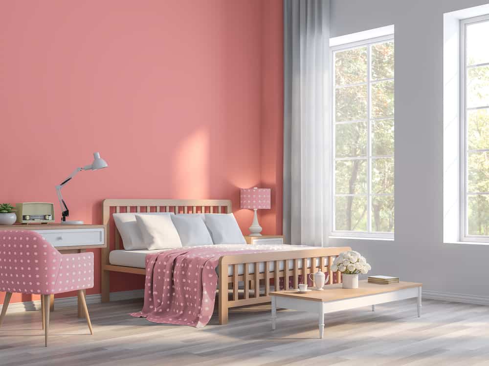 Coral pink bedroom with nature view 3d render.The Rooms have wooden floors and Coral pink empty walls,Furnished with pink fabric furniture,There are large window sunlight shining into the room.