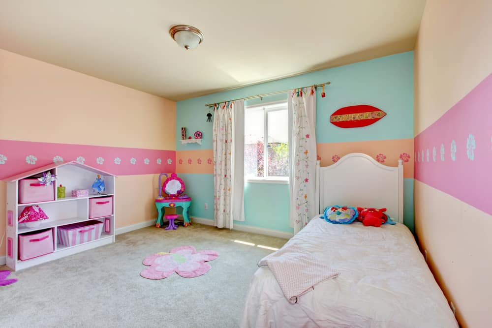 Baby girl bedroom with white bed, beige carpet.
