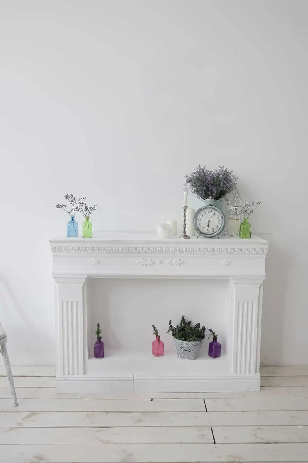 decorative fireplace with ornaments and a blank picture on the wall in the living room.