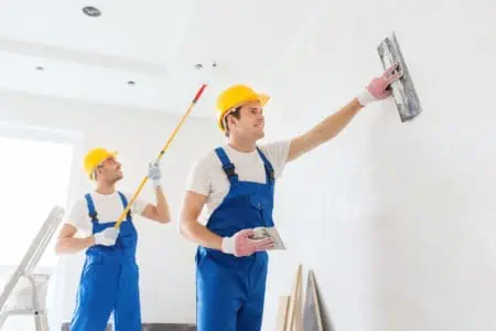 group of builders with tools indoors