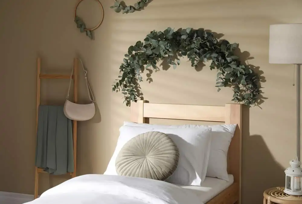 Stylish bedroom decorated with beautiful eucalyptus garland