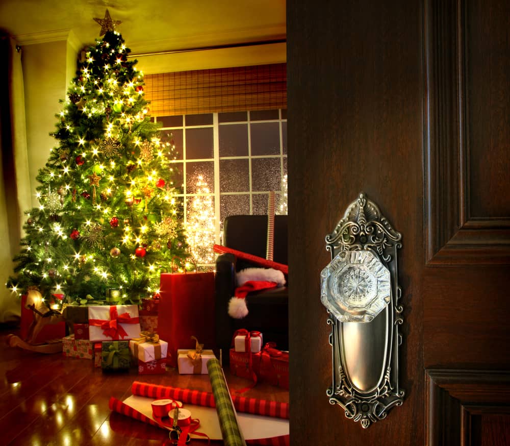 Door opening into a beautiful living room decorated for Christmas