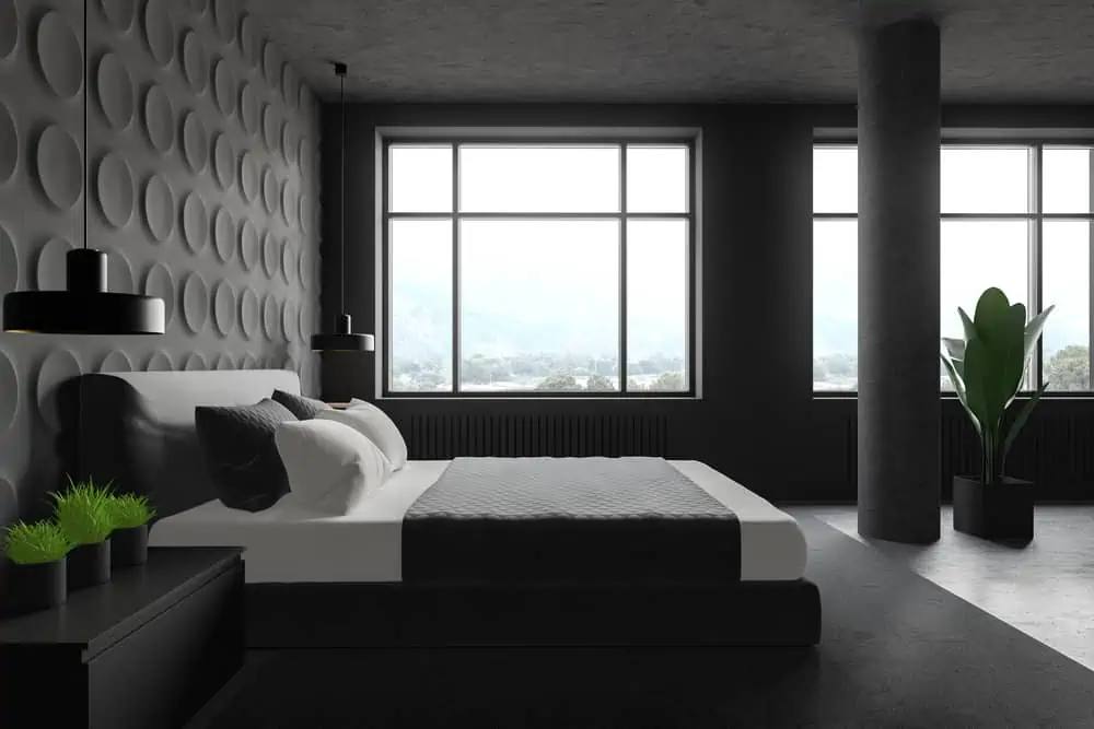 Side view of stylish bedroom with gray geometric pattern walls, concrete floor, big windows, king size bed and bedside table with plants. 3d rendering