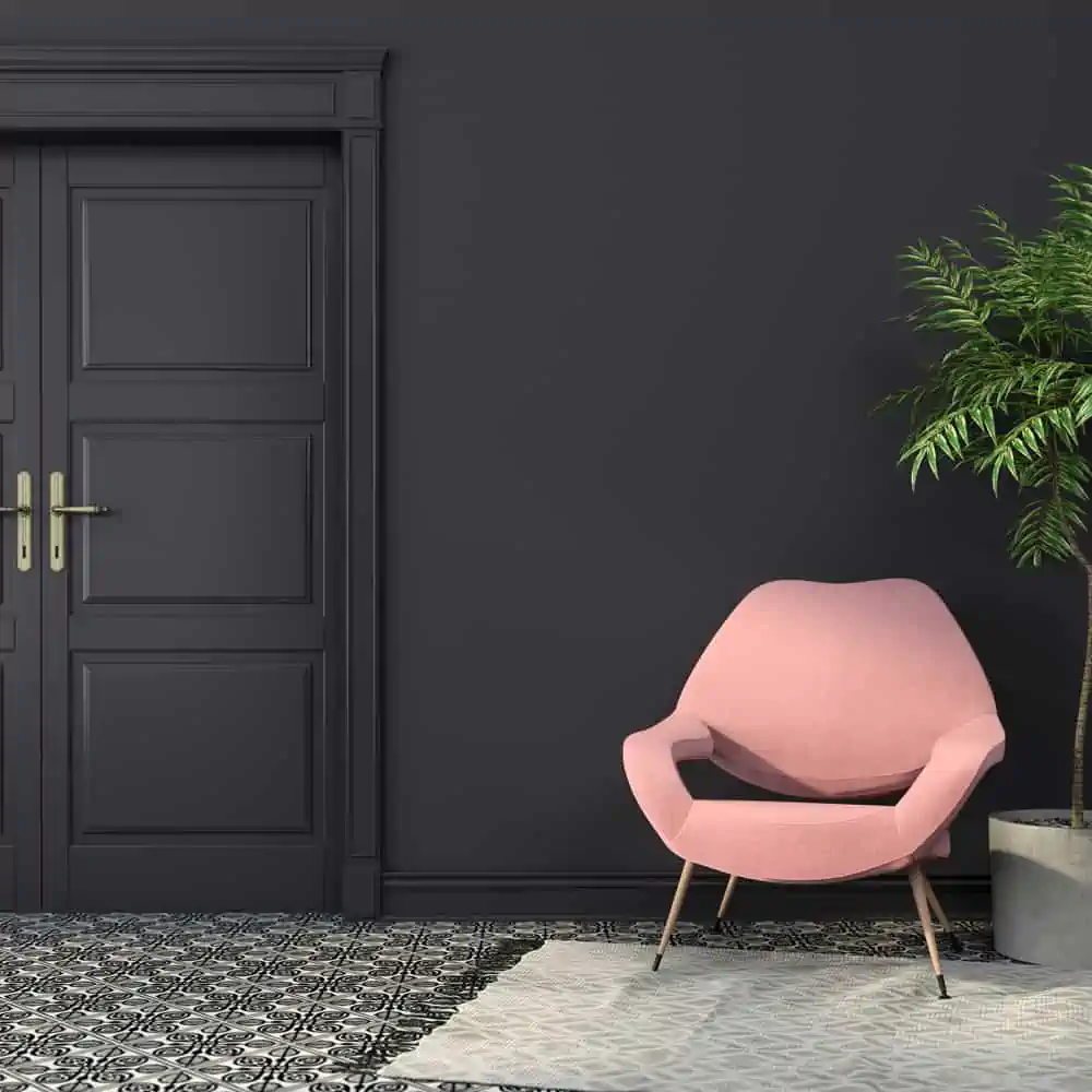 Pink armchair in a black interior