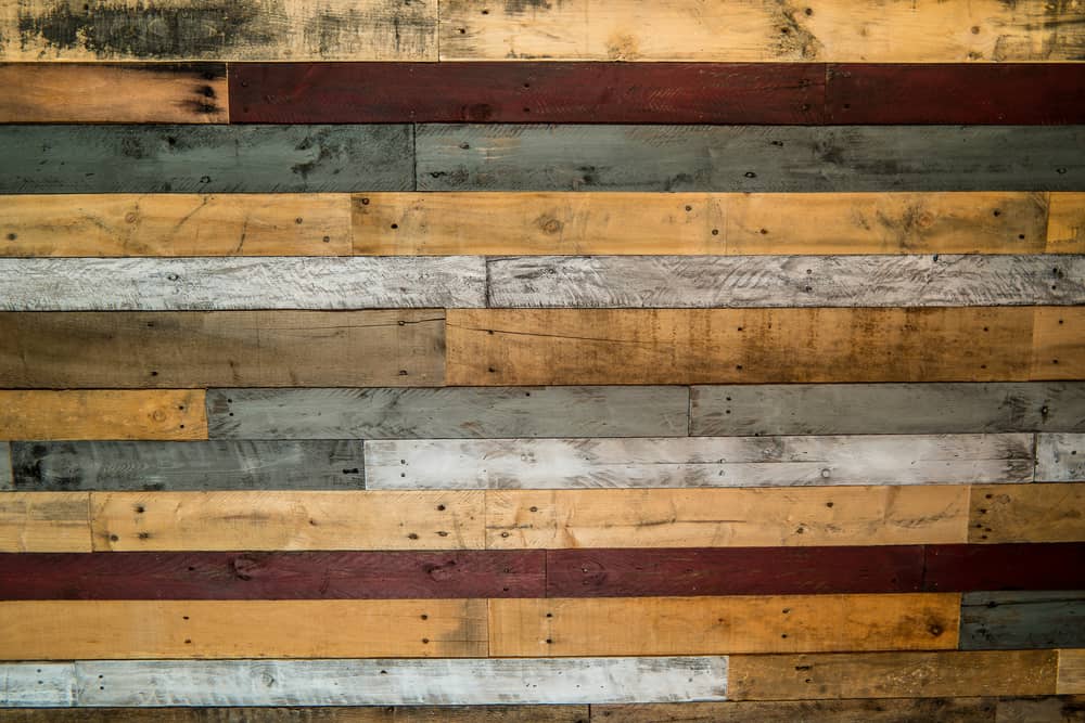 Rustic pallet wood wall with white, grays, browns, and red colors for backgrounds, displays, flat lays or copy space