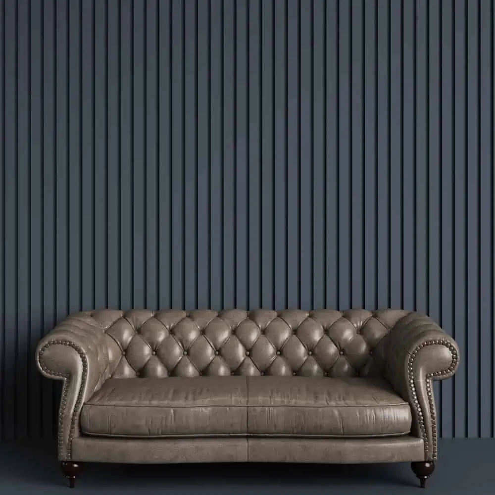 Classic tufted sofa in gray empty room with relief stripe wall. Minimal concept.Digital Illustration.3d rendering