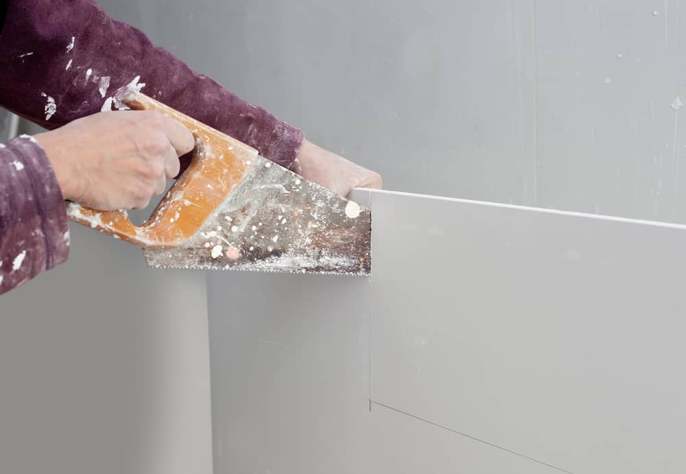 cutting plasterboard plaster hand dirty saw