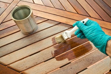 Closeup of person holding a rush over a deck
