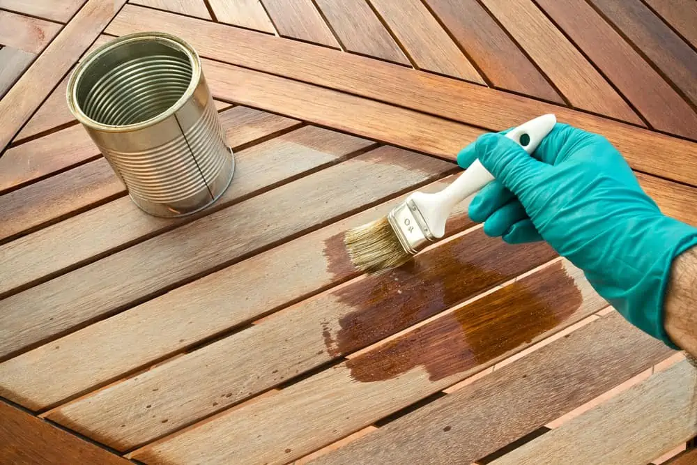 Closeup of person holding a rush over a deck