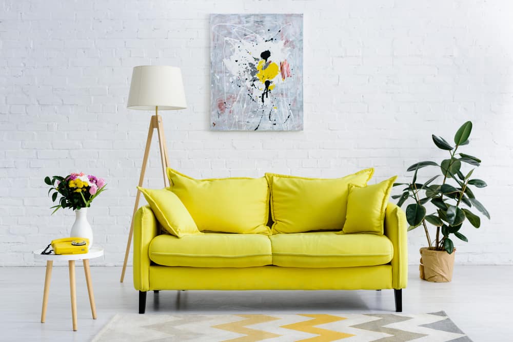 Yellow couch in a scandy living room