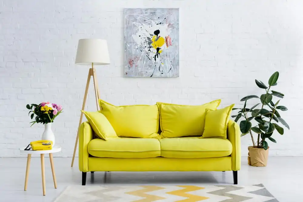 Yellow couch in a scandy living room