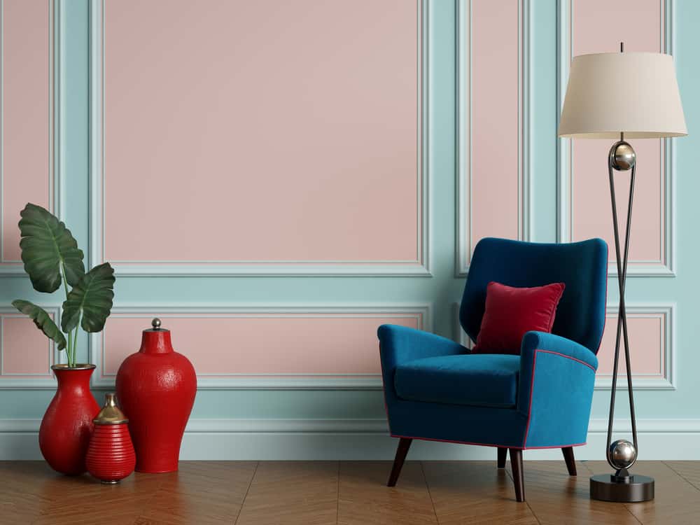 Classic interior with blue armchair and floor lamp with copy space.Pastel blue and pink color walls with mouldings,ornated cornice. Floor parquet herringbone.Digital Illustration.3d rendering